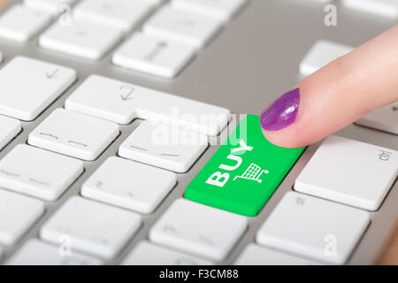 Female finger clicking on BUY button Stock Photo