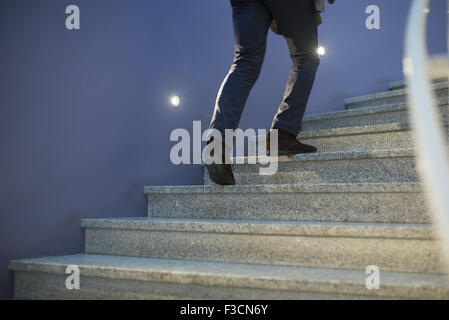 Man going up stairs, low section Stock Photo