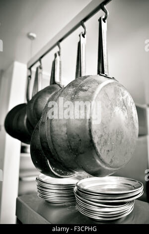 Pans hanging in kitchen Stock Photo