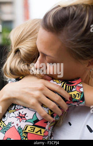 Mother embracing young daughter Stock Photo