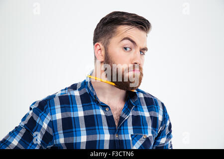 Portrait of a funny man with pencil in beard isolated on a white background Stock Photo