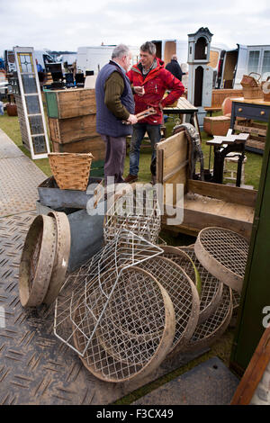 UK, England, Lincolnshire, Lincoln, Antiques Fair, dealer and customer on well stocked stall Stock Photo