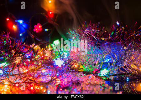 bright colored garlands bulb shines in the dark background,  selective focus Stock Photo