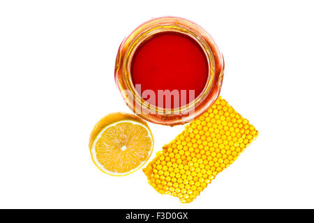 Fresh honey, chamomile  and lemon on white isolated background Stock Photo