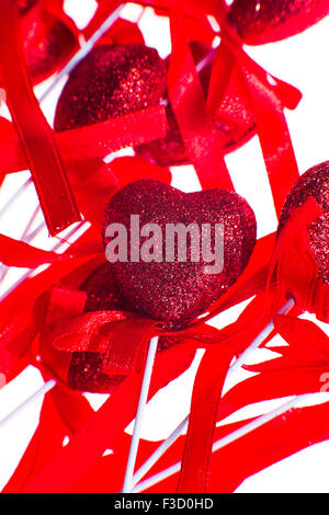 Red valentine heart shaped decorations with  ribbon and bows isolated over white background. Stock Photo
