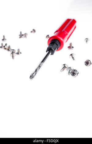 an isolated short of yellow handle screwdriver  and screws Stock Photo
