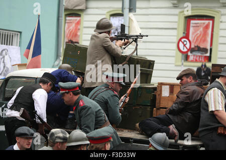 Reenactors dressed as the Czech insurgents defend a barricade during the reenactment of the 1945 Prague uprising in Prague, Czech Republic, on May 9, 2015. Stock Photo