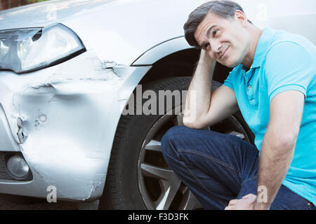 Unhappy Driver Inspecting Damage After Car Accident Stock Photo