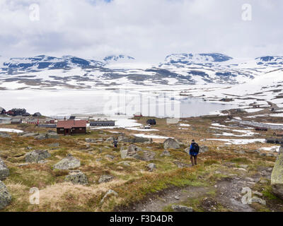 Norwegian mountain scene, young siblings and grandad returning from a hike to Finse, Hardangervidda Norway, Stock Photo