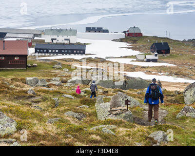 Norwegian mountain scene, young siblings and grandad returning from a hike to Finse, Hardangervidda Norway, Stock Photo