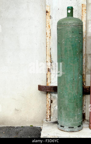 Colored big gas bottles in the street, green Stock Photo