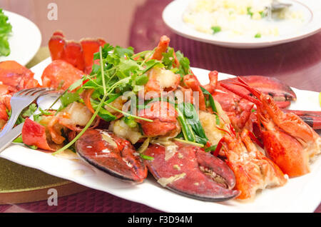 Plate of lobster fried on a wok with green coriander Stock Photo