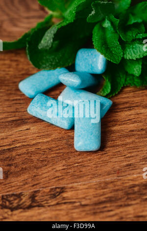 chewing gum and green  mint on a wooden background Stock Photo