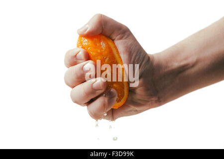 man dramatic squeezes orange. Concept squeezed a man  is tired from work. Stock Photo