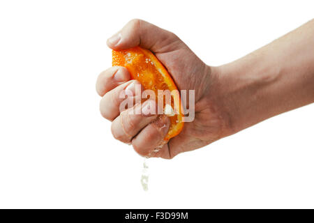 man dramatic squeezes orange. Concept squeezed a man  is tired from work. Stock Photo