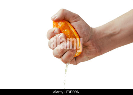 man dramatic squeezes orange. Concept squeezed a man  is tired from work. Stock Photo