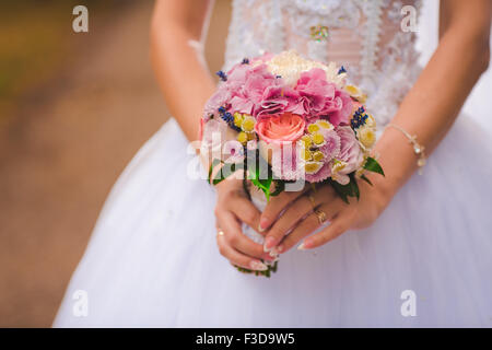 Beautiful wedding bouquet in hands of the  bride Stock Photo