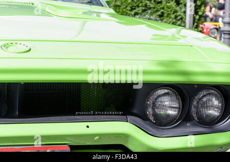 TORREJON DE ARDOZ, SPAIN - OCTOBER 3th 2015: Meeting of classic american cars, during the patronal festivals, by the streets of Torrejon de Ardoz, on October 3th 2015. Front zone detail of, green car, Plymouth Road Runner 440, of 1971. Stock Photo