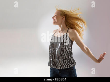 Happy woman dancing in studio Stock Photo