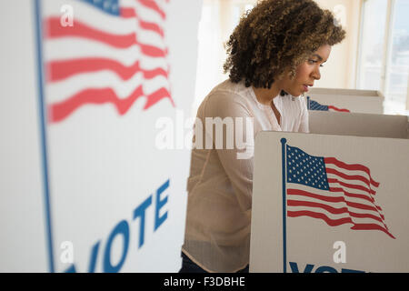 Young woman preparing voting booth