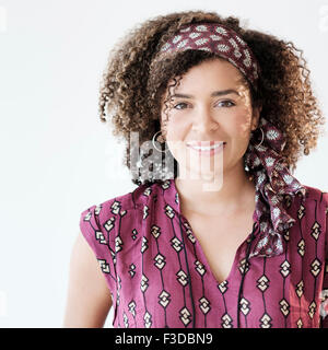 Portrait of smiling woman with curly hair Stock Photo