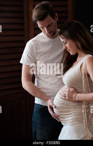 Man touching woman's abdomen Stock Photo