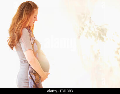 Side view of pregnant woman outdoors Stock Photo