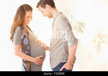 Pregnant woman holding hands with her boyfriend Stock Photo