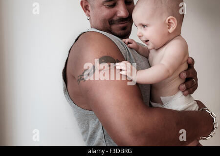 Studio shot of baby girl (2-5 months) with her father