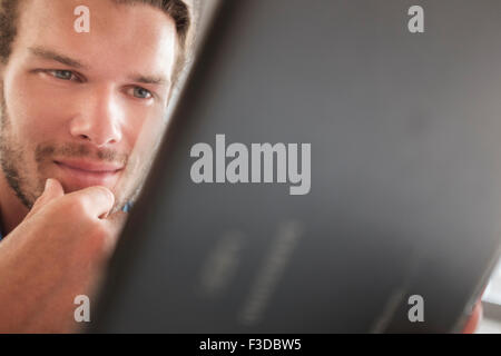 Mid-adult man using tablet pc Stock Photo