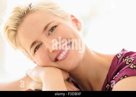 Portrait of smiling young woman indoors Stock Photo