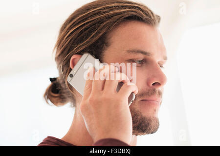 Mid-adult man talking on phone Stock Photo