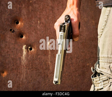 Man holding a gun Stock Photo - Alamy