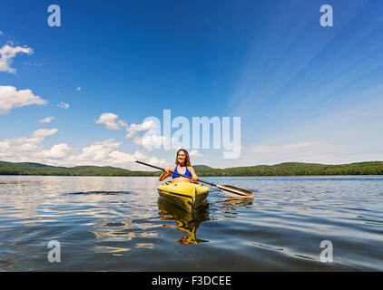Young woman kayaking on lake Stock Photo