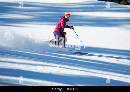 Woman skiing downhill Stock Photo