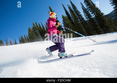 Woman skiing downhill Stock Photo