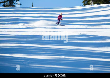 Woman skiing downhill Stock Photo