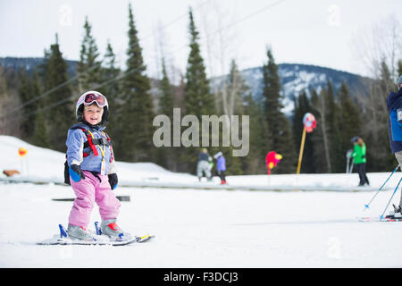 Little girl (2-3) learning skiing Stock Photo