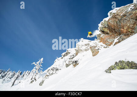 Young man jumping from ski slope