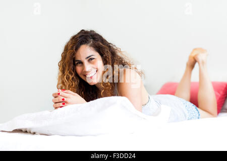 Woman lying on bed Stock Photo