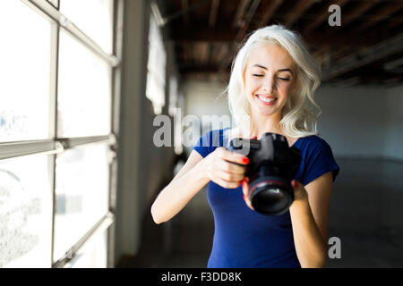 Woman using digital camera Stock Photo