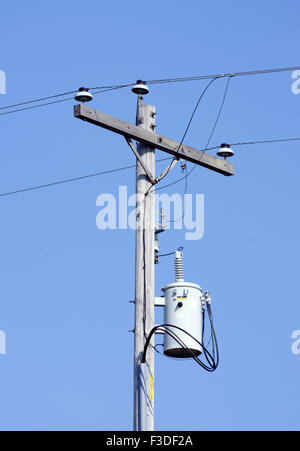 Overhead to underground connection point on electric transmission line Stock Photo