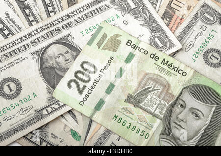 Dollars and Mexican Pesos assorted bills cash pile background Stock Photo