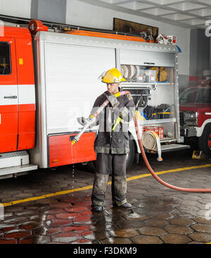 Fireman Holding Water Hose During Training Stock Photo