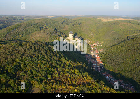 AERIAL VIEW. Castle of Karlstejn overlooking the market town of the same name on the valley floor. Bohemia, Czech Republic. Stock Photo