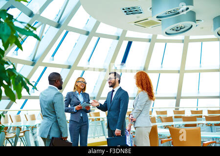 Group of modern employees interacting in office Stock Photo