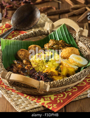 Lamprais. Curry, rice and vegetables in banana leaf. Sri Lanka Food Stock Photo