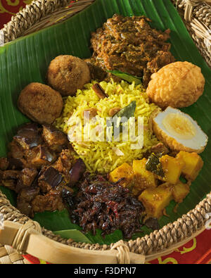 Lamprais. Curry, rice and vegetables in banana leaf. Sri Lanka Food Stock Photo