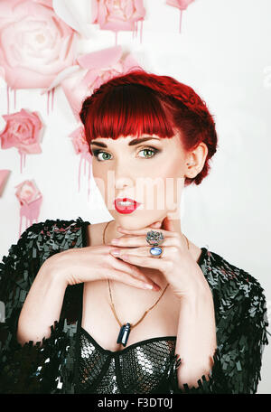 Beautifully romantic red haired girl in a contemporary studio setting Stock Photo