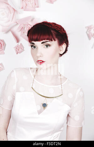Beautifully romantic red haired girl in a contemporary studio setting Stock Photo